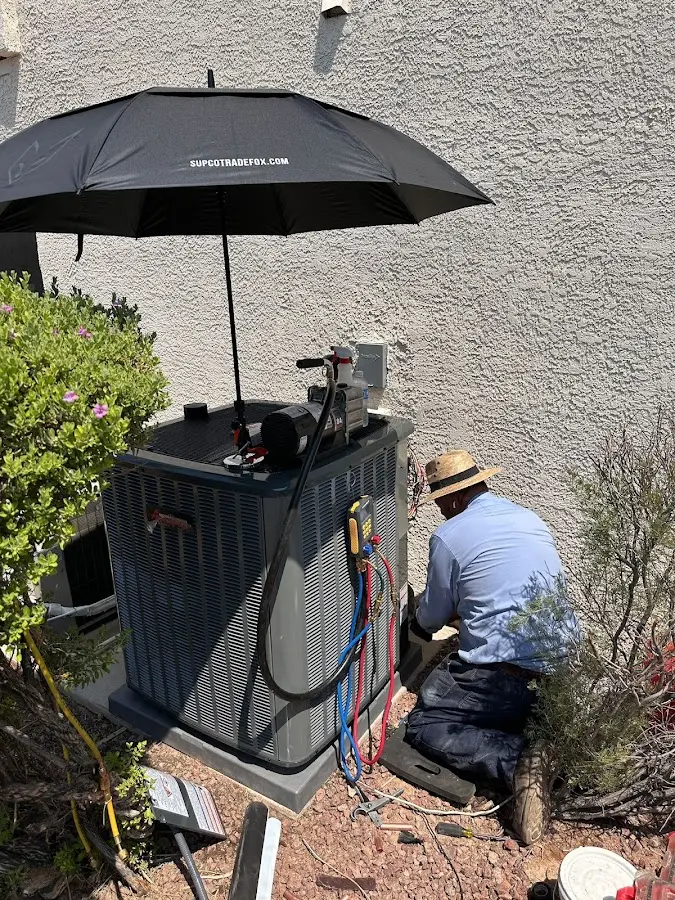 HVAC technician performing outdoor AC maintenance in Plattekill