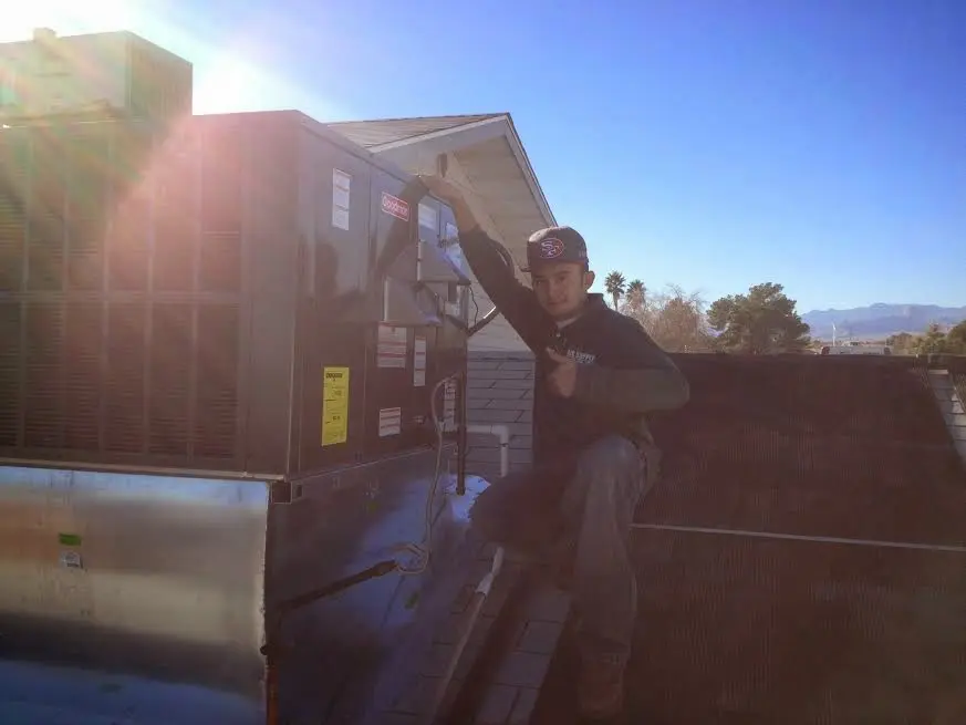 HVAC technician performing Boiler Repair on a rooftop unit in Plattekill